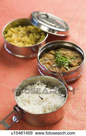Stock Photo - Close-up of tiffin boxes of rice and curry. Fotosearch