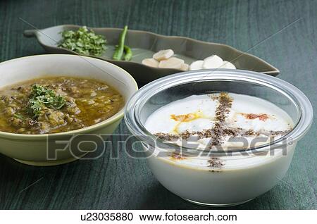 Stock Image - Close-up of two bowls of curry and curd. Fotosearch