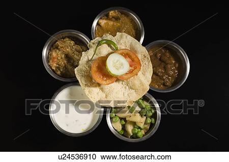 Stock Image - High angle view of assorted Indian food. Fotosearch