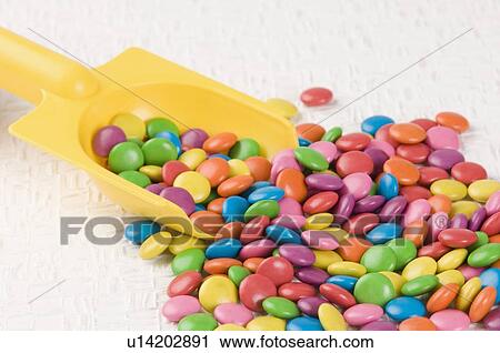 Stock Image - Assorted candies with a scoop. Fotosearch