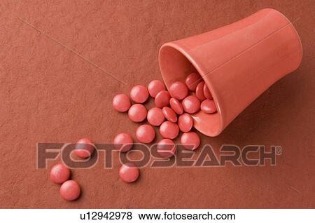 Candies spilling from a plastic glass View Large Photo Image Stock Photo - Candies spilling from a plastic glass. Fotosearch