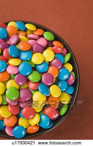 Stock Image - Close-up of a bowl filled with multi-colored candies. Fotosearch