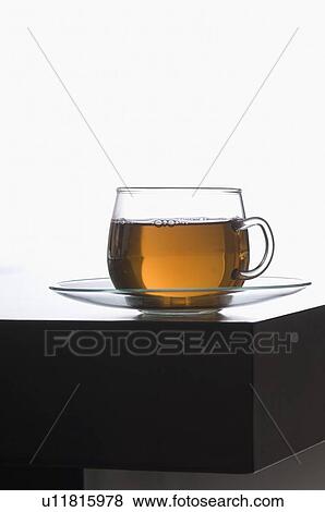 Stock Photo - Close-up of a cup of herbal tea on a saucer. Fotosearch