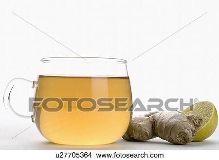 Picture - Close-up of a cup of herbal tea with ginger and lemon slice. Fotosearch