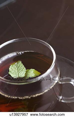 Stock Photo - Close-up of a cup of herbal tea with mint leaf in a cup. Fotosearch