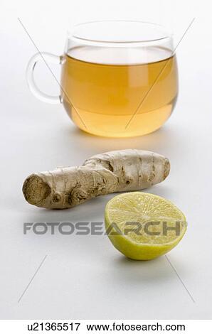 Stock Photo - Close-up of a cup of herbal tea with ginger and lemon slice. Fotosearch