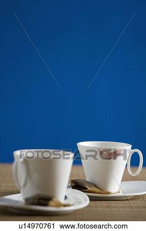 Stock Image - Close-up of a lipstick mark on a tea cup with teabags. Fotosearch