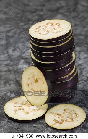 Stock Image - Close-up of a stack of slices of eggplants. Fotosearch