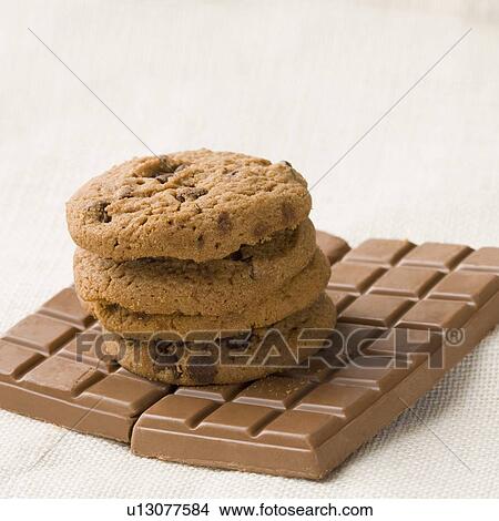 Picture - Close-up of brown biscuits on chocolate bars. Fotosearch