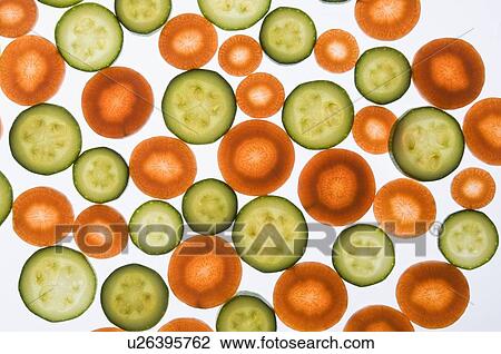 Stock Image - Close-up of carrot and cucumber slices. Fotosearch