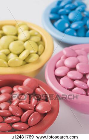 Stock Photo - Close-up of four bowls filled with candies. Fotosearch