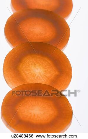 Stock Photograph - Close-up of four slices of carrot. Fotosearch