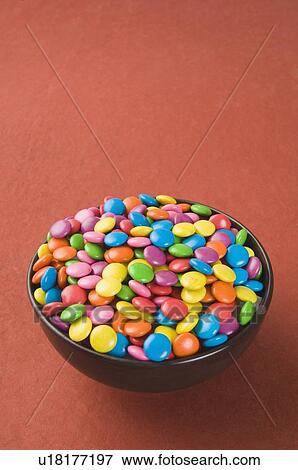 Stock Photo - High angle view of a bowl filled with multi-colored candies. Fotosearch