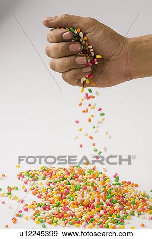 Jellybeans falling from a person's hand View Large Photo Image Stock Photo - Jellybeans falling from a person's hand. Fotosearch