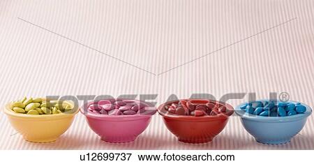 Stock Photo - Row of four bowls filled with candies. Fotosearch