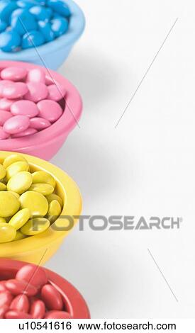 Row of four bowls filled with candies View Large Photo Image Stock Photograph - Row of four bowls filled with candies. Fotosearch
