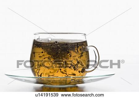 Tea leaves floating in a cup of herbal tea View Large Photo Image Stock Photo - Tea leaves floating in a cup of herbal tea. Fotosearch