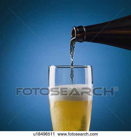 Beer being poured into a beer glass View Large Photo Image Stock Image - Beer being poured into a beer glass. Fotosearch
