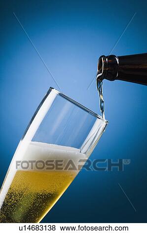 Stock Photo - Beer being poured into a beer glass. Fotosearch