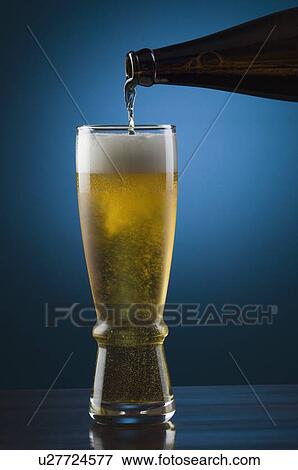 Beer being poured into a beer glass View Large Photo Image Stock Photo - Beer being poured into a beer glass. Fotosearch