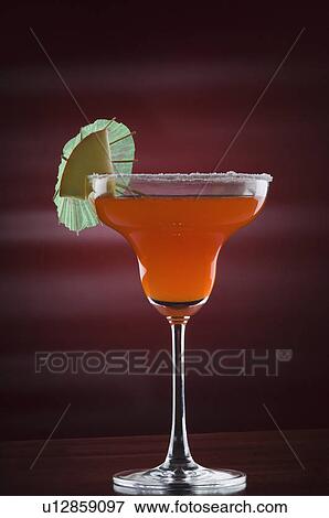 Close-up of a drink umbrella and an apple slice on a glass of margarita View Large Photo Image Stock Photo - Close-up of a drink umbrella and an apple slice on a glass of margarita. Fotosearch