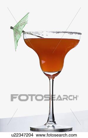 Picture - Close-up of a drink umbrella on a glass of margarita. Fotosearch