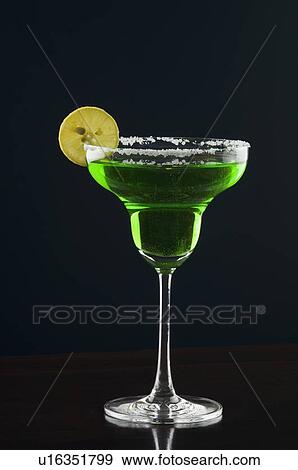 Stock Photo - Close-up of a lemon slice on a glass of margarita. Fotosearch
