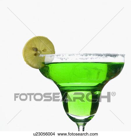 Picture - Close-up of a slice of lemon on a glass of margarita. Fotosearch