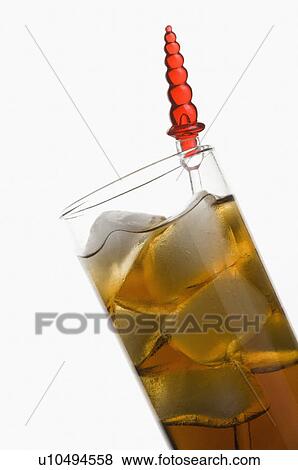 Stock Photo - Close-up of a stirrer in a glass of ice tea. Fotosearch