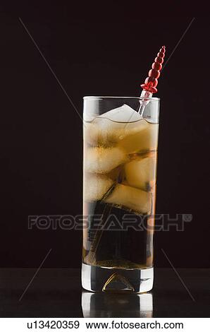 Stock Photo - Close-up of a stirrer in a glass of ice tea. Fotosearch