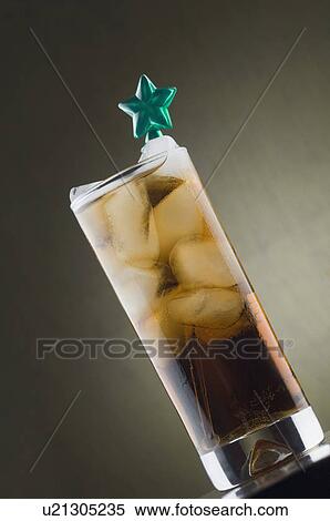 Stock Photography - Close-up of a stirrer in a glass of ice tea. Fotosearch