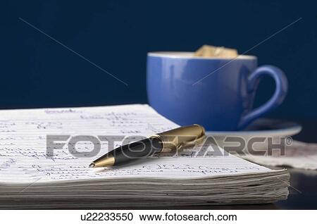 Close-up of a pen on a notepad with a tea cup View Large Photo Image Stock Image - Close-up of a pen on a notepad with a tea cup. Fotosearch