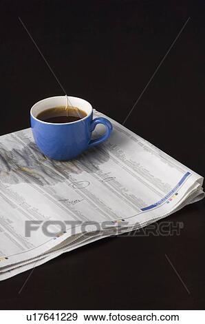 Close-up of a teabag in a cup of tea on a document View Large Photo Image Stock Photo - Close-up of a teabag in a cup of tea on a document. Fotosearch