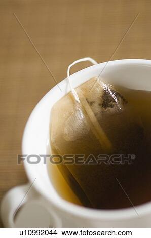 Picture - Close-up of a teabag in a cup of tea. Fotosearch
