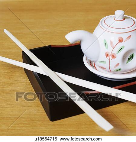 High angle view of a tea kettle with a pair of chopsticks on a tray View Large Photo Image Stock Photography - High angle view of a tea kettle with a pair of chopsticks on a tray. Fotosearch