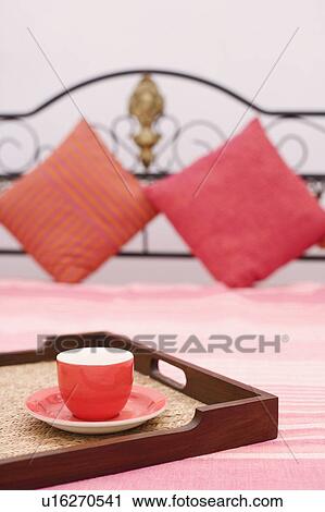 Tea cup in a tray on the bed View Large Photo Image Stock Image - Tea cup in a tray on the bed. Fotosearch