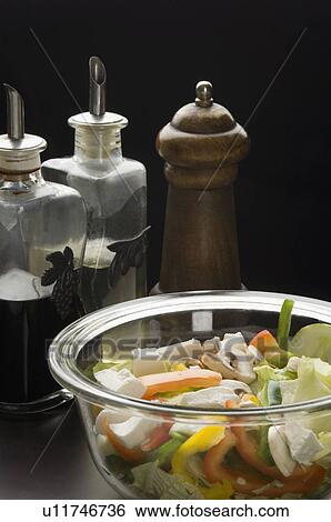 Close-up of a bowl of salad with a salt shaker and a pepper shaker View Large Photo Image Stock Photograph - Close-up of a bowl of salad with a salt shaker and a pepper shaker. Fotosearch