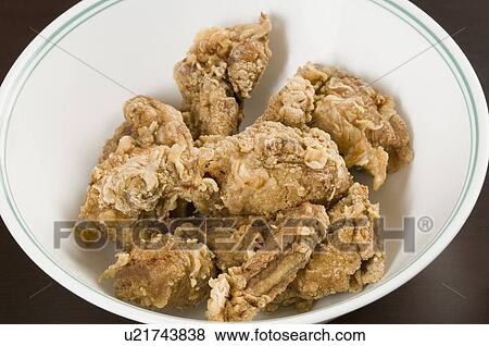 Stock Photo - Close-up of fried chicken drumsticks in a bowl. Fotosearch