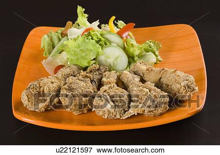 Stock Photo - Close-up of roast chicken with salad in a plate. Fotosearch