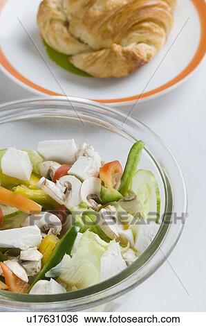 High angle view of a bowl of salad and a plate of bun View Large Photo Image Stock Photograph - High angle view of a bowl of salad and a plate of bun. Fotosearch