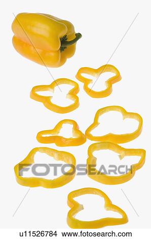 Picture - Close-up of a yellow bell pepper with slices. Fotosearch