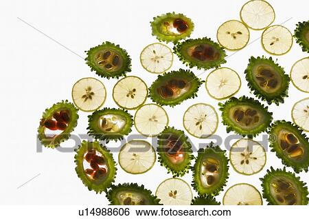 Stock Photograph - Close-up of slices of bitter melon and lemon. Fotosearch