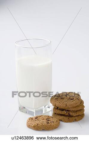 Stock Photograph - Close-up of a glass of milk with chocolate chip cookies. Fotosearch