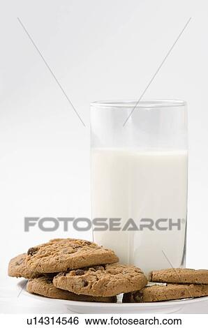 Stock Photograph - Close-up of a glass of milk with chocolate chip cookies. Fotosearch