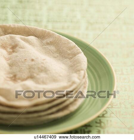 Stock Photo - Close-up of chapattis in a plate. Fotosearch
