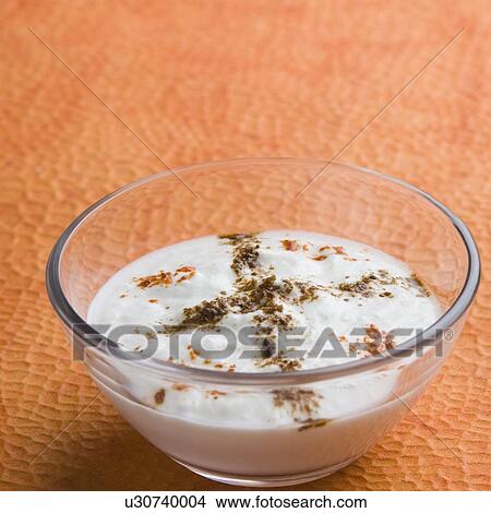 Picture - Close-up of rayta in a glass bowl. Fotosearch