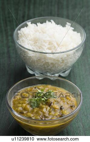Stock Image - Close-up of rice in a glass bowl with chickpea curry. Fotosearch