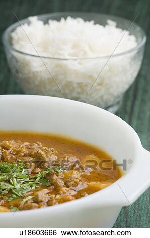 Stock Photograph - Close-up of rice in a glass bowl with chickpea curry. Fotosearch