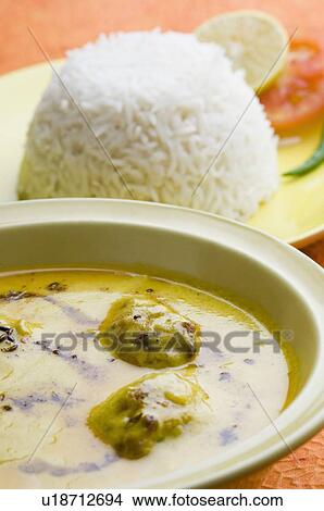 Picture - Close-up of rice in a plate with kadi pakora. Fotosearch