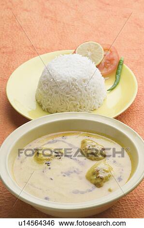 Stock Photograph - Close-up of rice in a plate with kadi pakora. Fotosearch